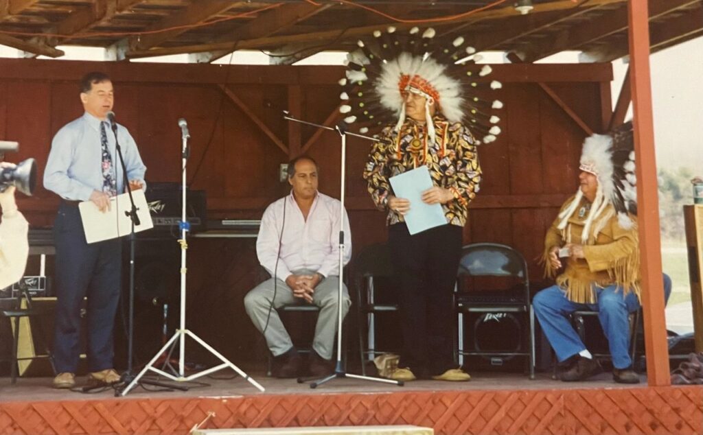 25 years after Gov. Salmon's executive order, Chief Homer St. Francis (Missisquoi), and Chief Walter Watso (Odanak) on stage with with Gov. Howard Dean and Jeff Benay at the first Abenaki Heritage Celebration (1992).